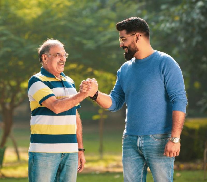 Two males chatting together in the park